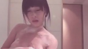 Japanese girl plays with big tits in the bath